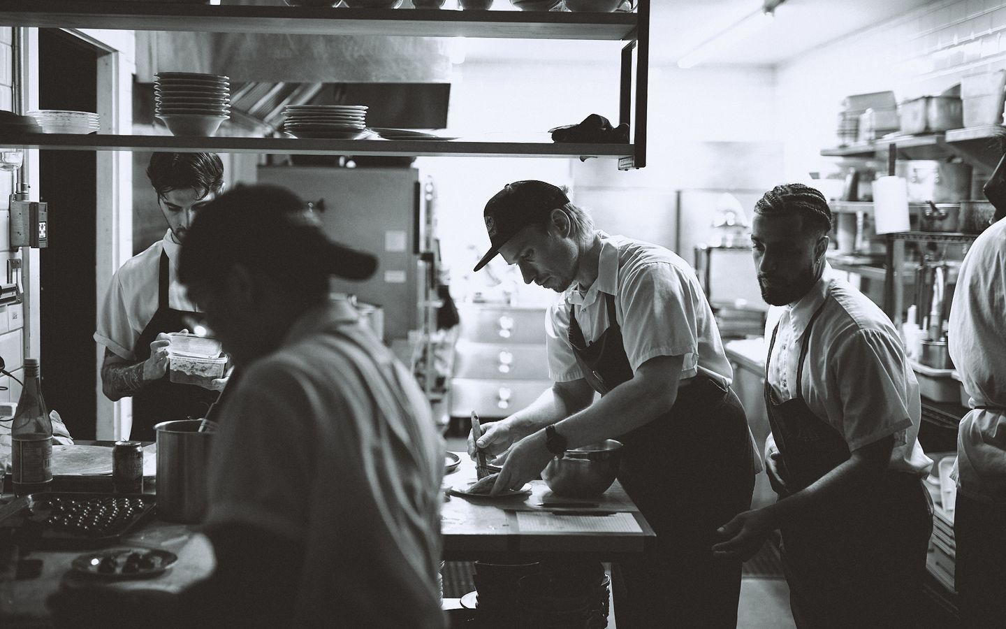 Kitchen cooks working at Espace Old Mill farm-to-table restaurant.
